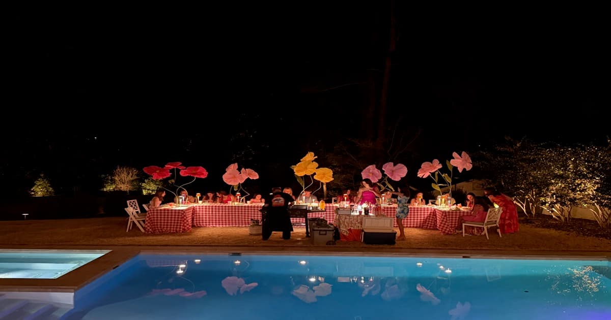 Hibachi catering party by the pool at night
